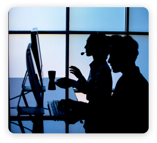 silhouette of employees talking in front of computer