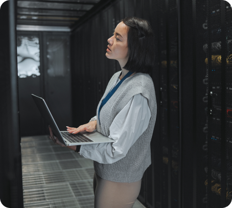 woman checking database while holding a laptop